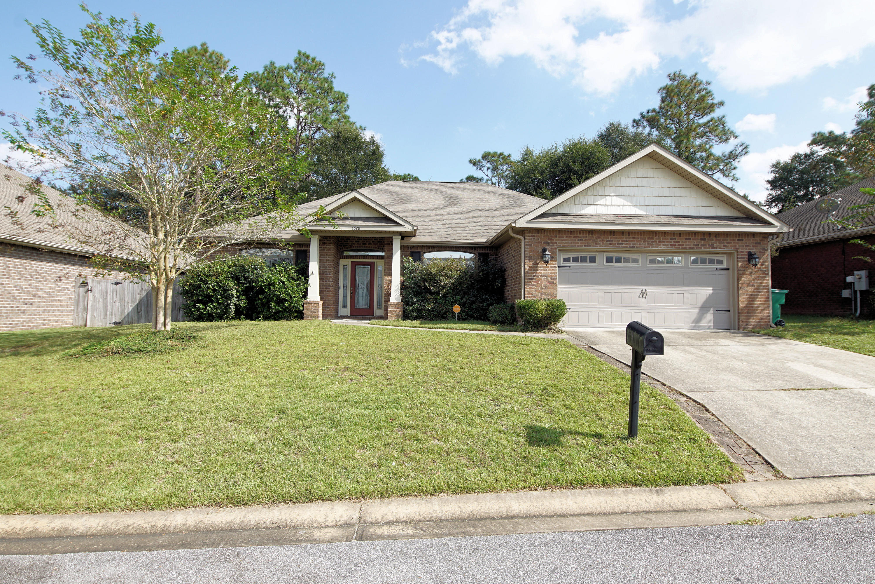 4628 Hermosa Road Crestview, FL 32539 - Photo 3 of 40 a front view of a house with garden