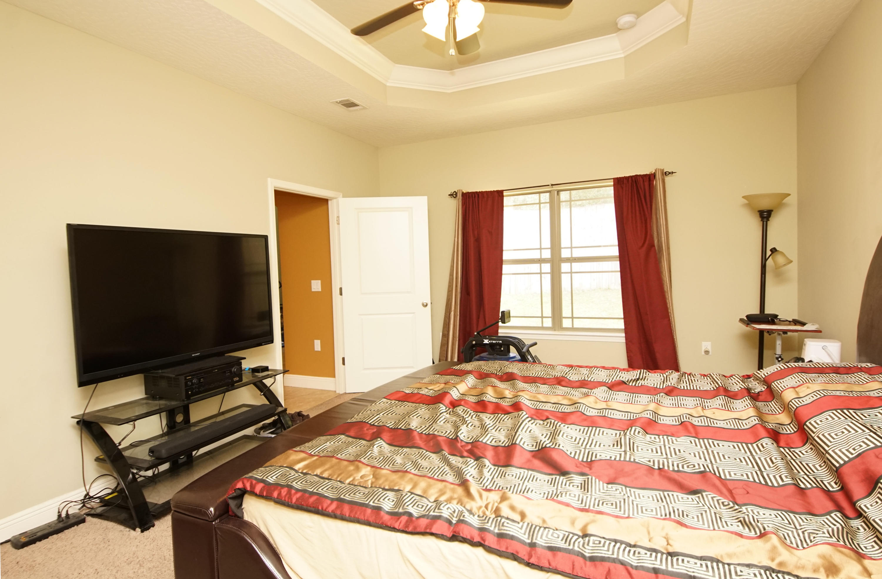 4628 Hermosa Road Crestview, FL 32539 - Photo 22 of 40 a bedroom with a bed and a flat screen tv