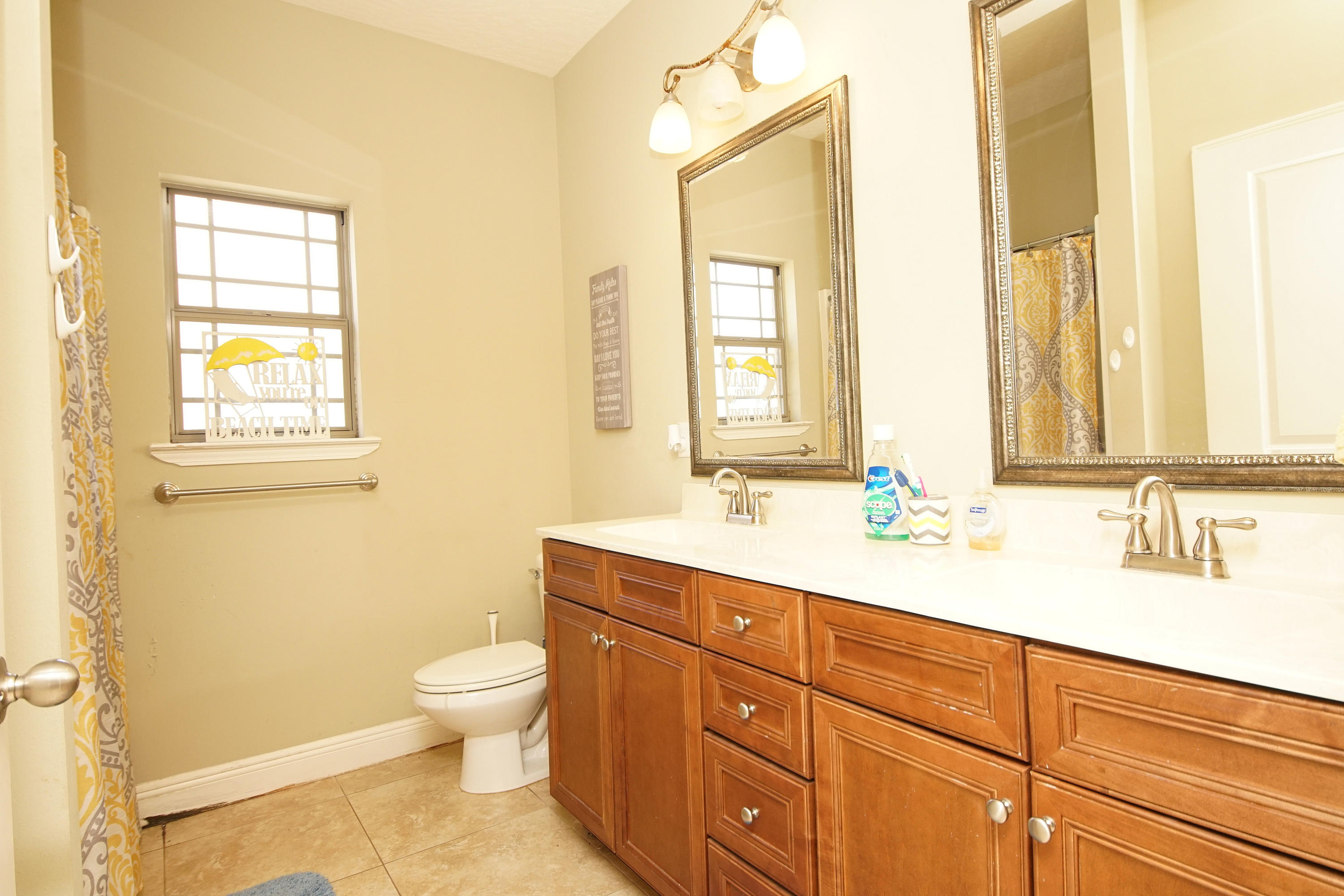 4628 Hermosa Road Crestview, FL 32539 - Photo 34 of 40 a bathroom with a granite countertop toilet sink and mirror