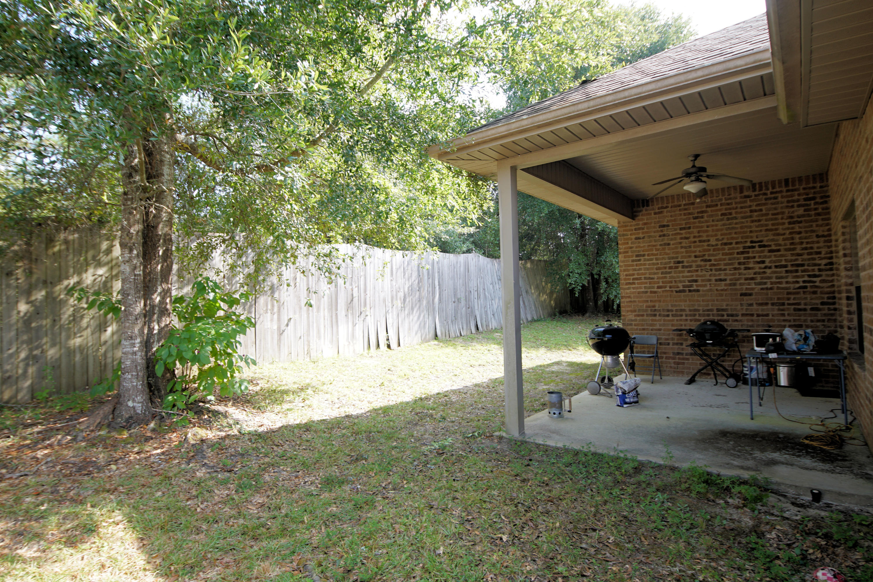 4628 Hermosa Road Crestview, FL 32539 - Photo 38 of 40 a view of backyard with a patio and outdoor seating