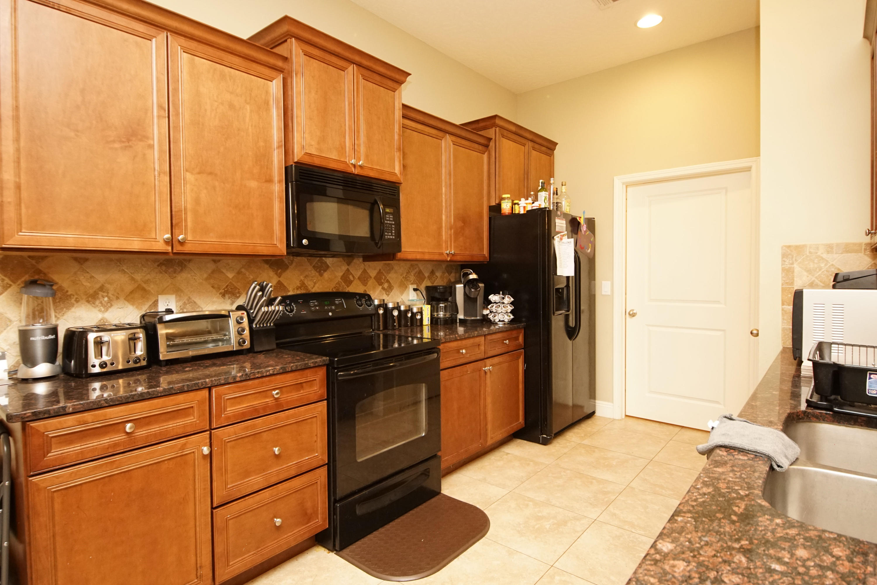 4628 Hermosa Road Crestview, FL 32539 - Photo 6 of 40 a kitchen with stainless steel appliances granite countertop a refrigerator stove and sink
