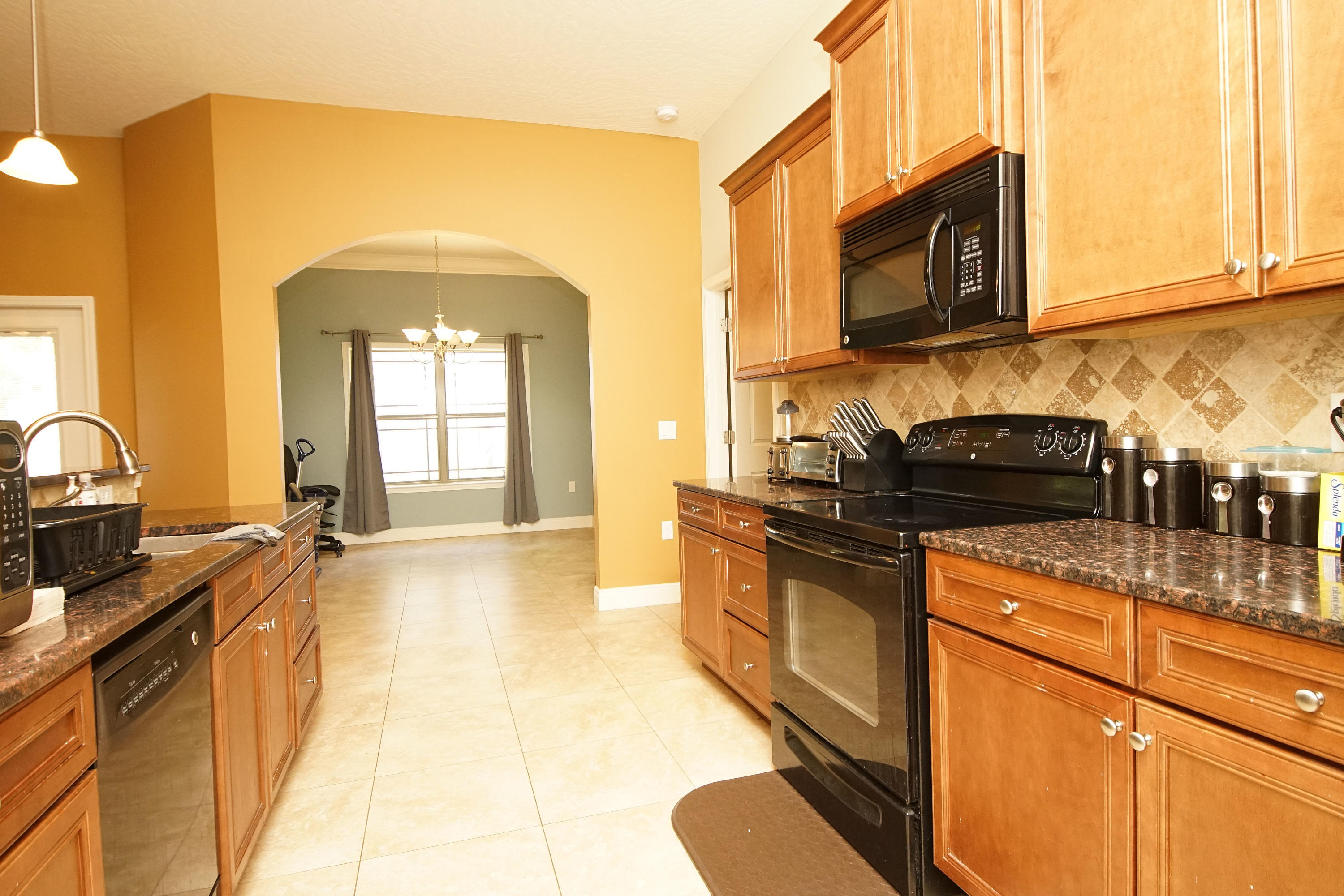 4628 Hermosa Road Crestview, FL 32539 - Photo 10 of 40 a kitchen with stainless steel appliances granite countertop a stove a sink and a microwave