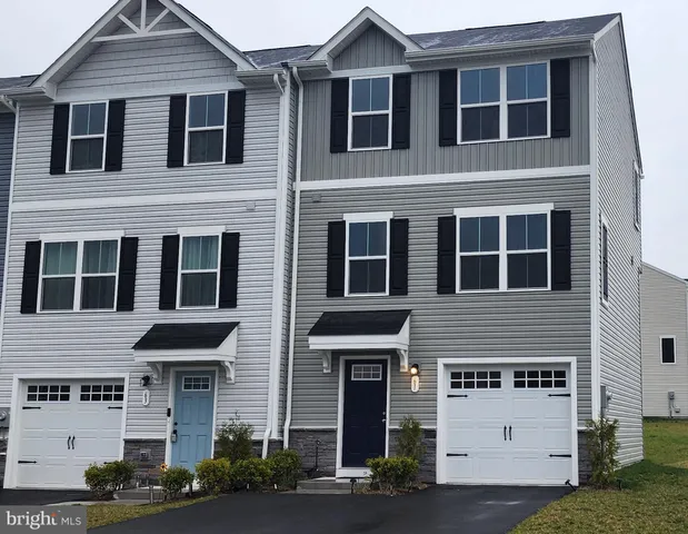 a front view of a house with garage