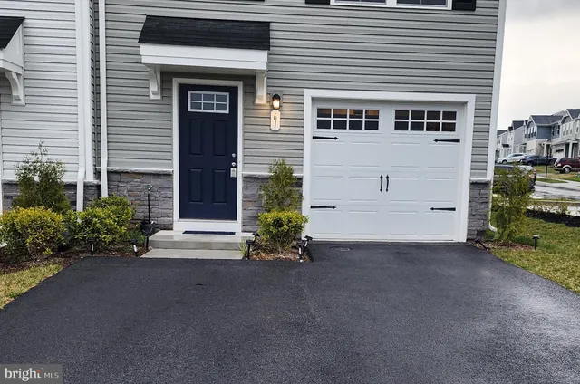 a view of a house with a yard and garage
