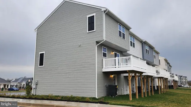 a view of house with yard and deck
