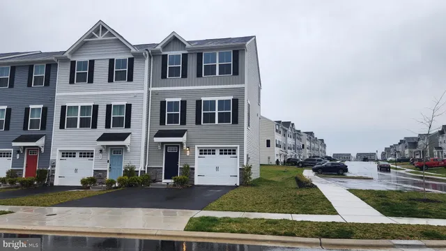 a front view of a residential apartment building with a yard
