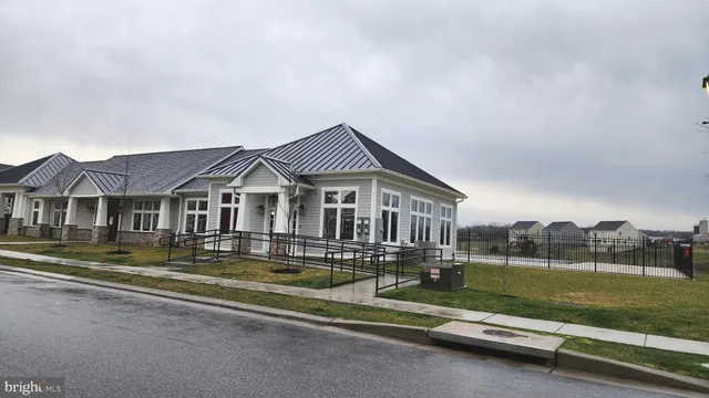 a front view of a house with a yard table and chairs