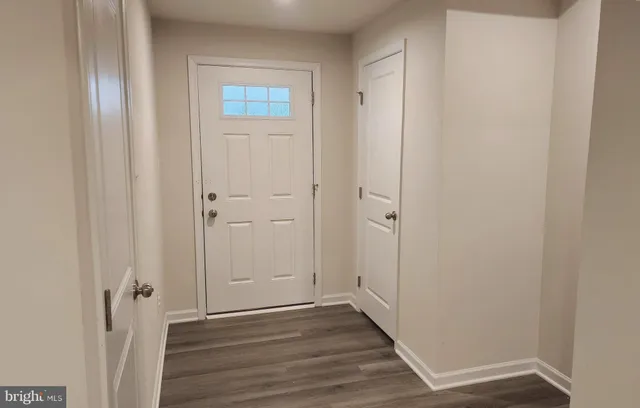 a view of a hallway with wooden floor