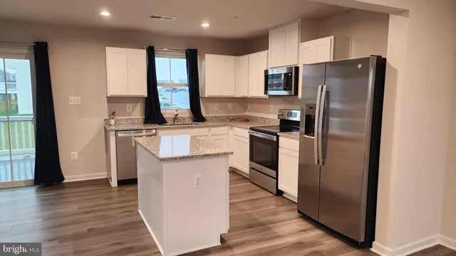 a kitchen with stainless steel appliances a refrigerator stove and sink