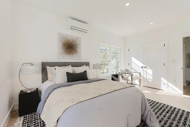 a bedroom with bed and a window