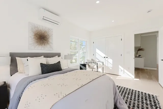 a bedroom with double bed and a window