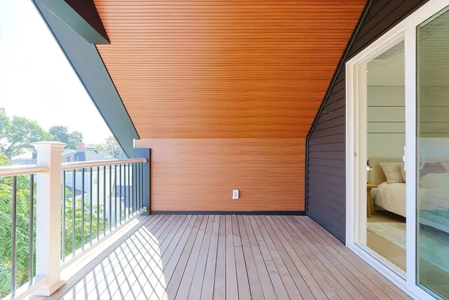 a view of a balcony with wooden floor