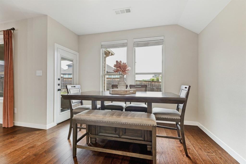 4136 Lightstone Lane Celina, TX 75009 - Photo 20 of 39 a view of a dining room with furniture window and wooden floor
