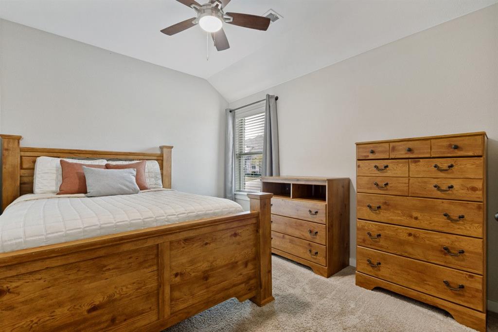 4136 Lightstone Lane Celina, TX 75009 - Photo 23 of 39 a bedroom with a bed and a dresser