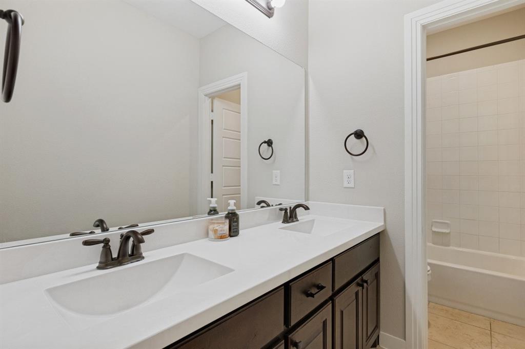 4136 Lightstone Lane Celina, TX 75009 - Photo 24 of 39 a bathroom with a sink and a mirror