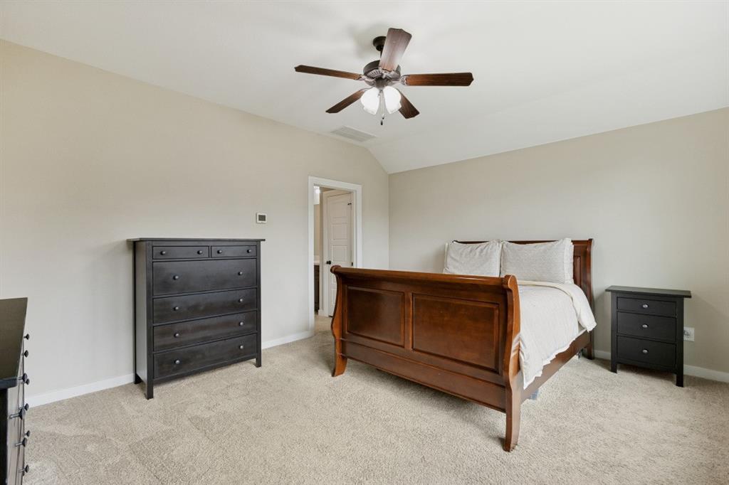4136 Lightstone Lane Celina, TX 75009 - Photo 25 of 39 a bedroom with a bed and a cabinets