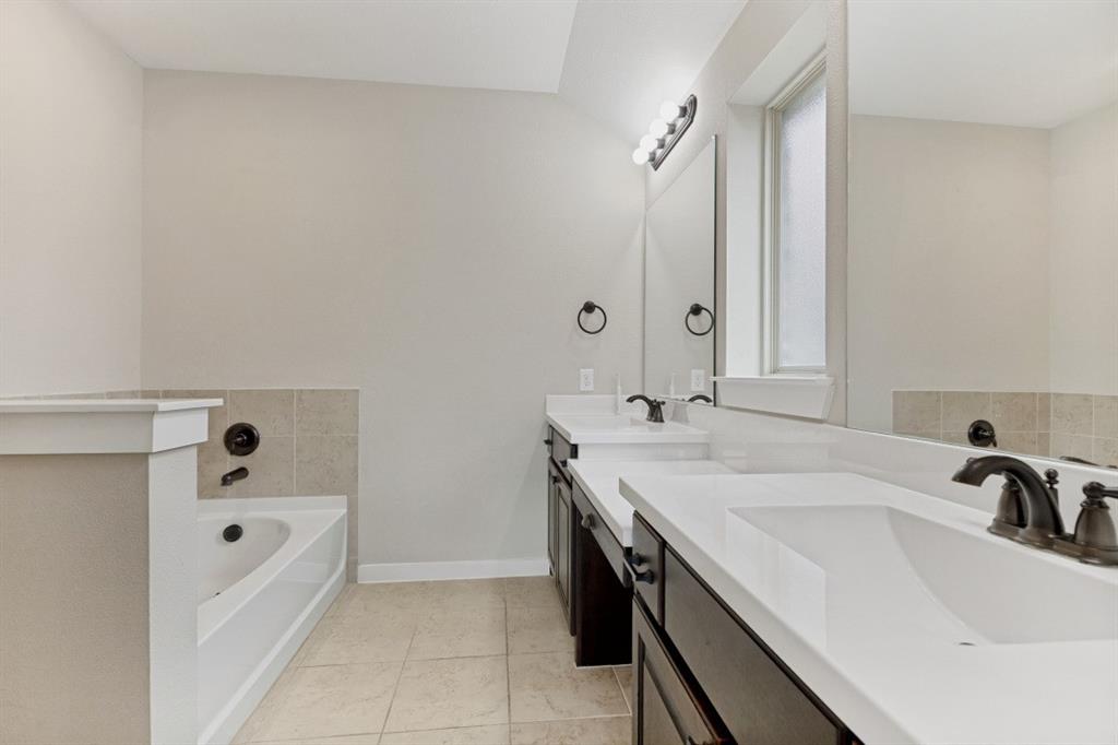 4136 Lightstone Lane Celina, TX 75009 - Photo 29 of 39 a bathroom with a tub sink and mirror
