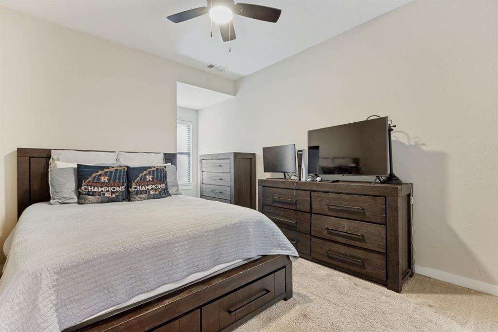 4136 Lightstone Lane Celina, TX 75009 - Photo 30 of 39 a bedroom with a bed and tv