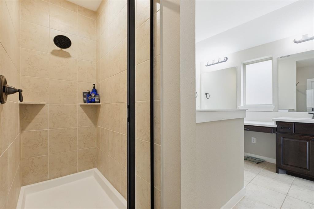 4136 Lightstone Lane Celina, TX 75009 - Photo 31 of 39 a bathroom with a sink and a mirror