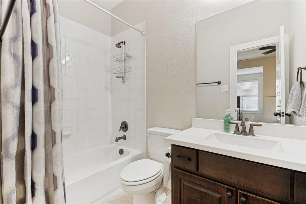 4136 Lightstone Lane Celina, TX 75009 - Photo 32 of 39 a bathroom with a sink toilet vanity and shower