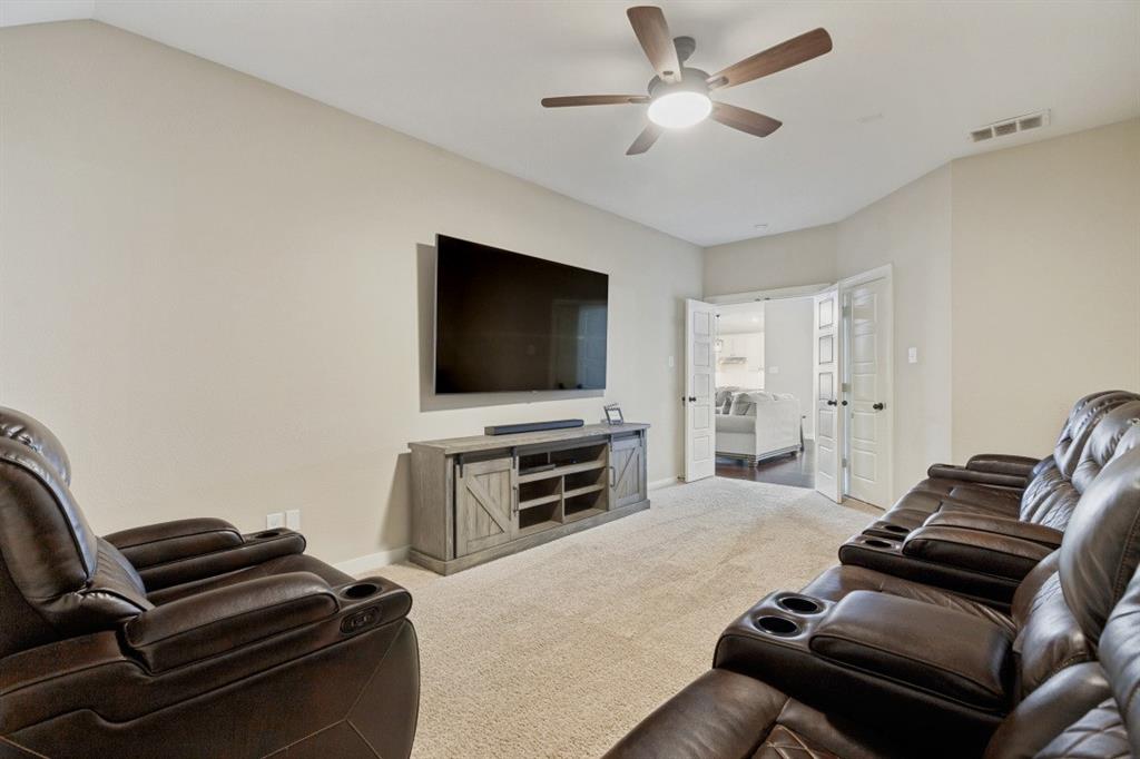 4136 Lightstone Lane Celina, TX 75009 - Photo 7 of 39 a living room with furniture and a flat screen tv