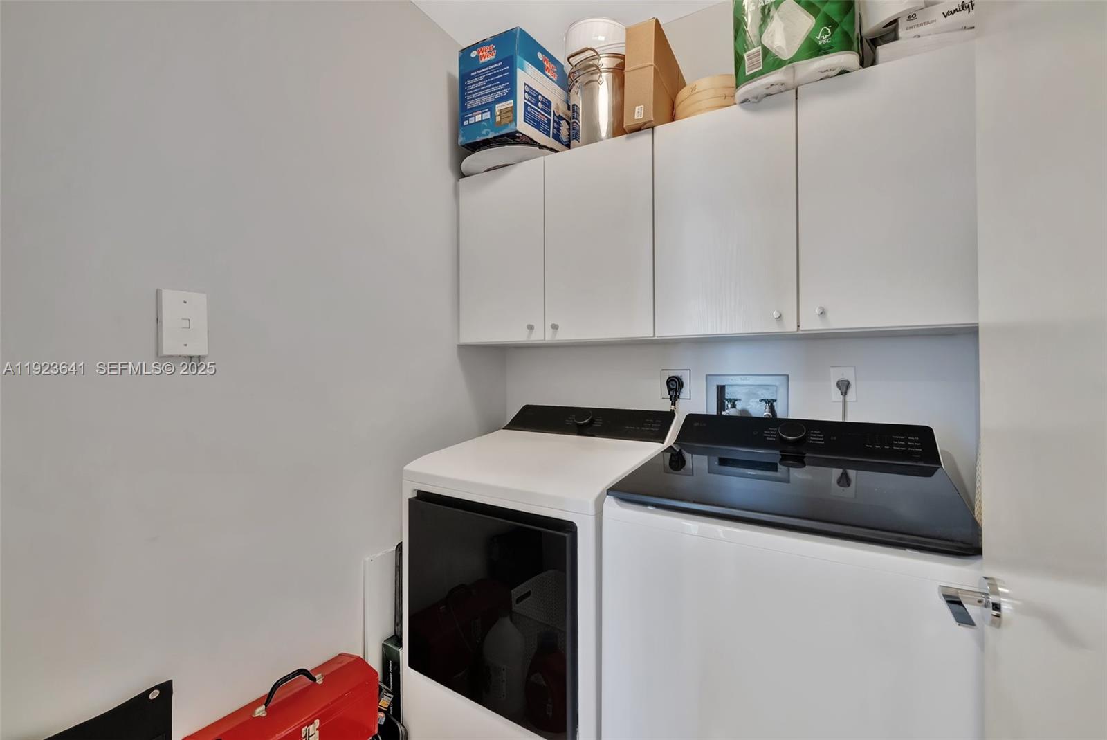 7000 Island Boulevard, Unit 1701 Aventura, FL 33160 - Photo 13 of 65 a utility room with dryer and washer