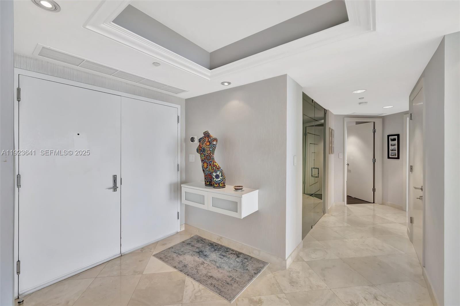 7000 Island Boulevard, Unit 1701 Aventura, FL 33160 - Photo 19 of 65 a view of a hallway with bathroom and shower
