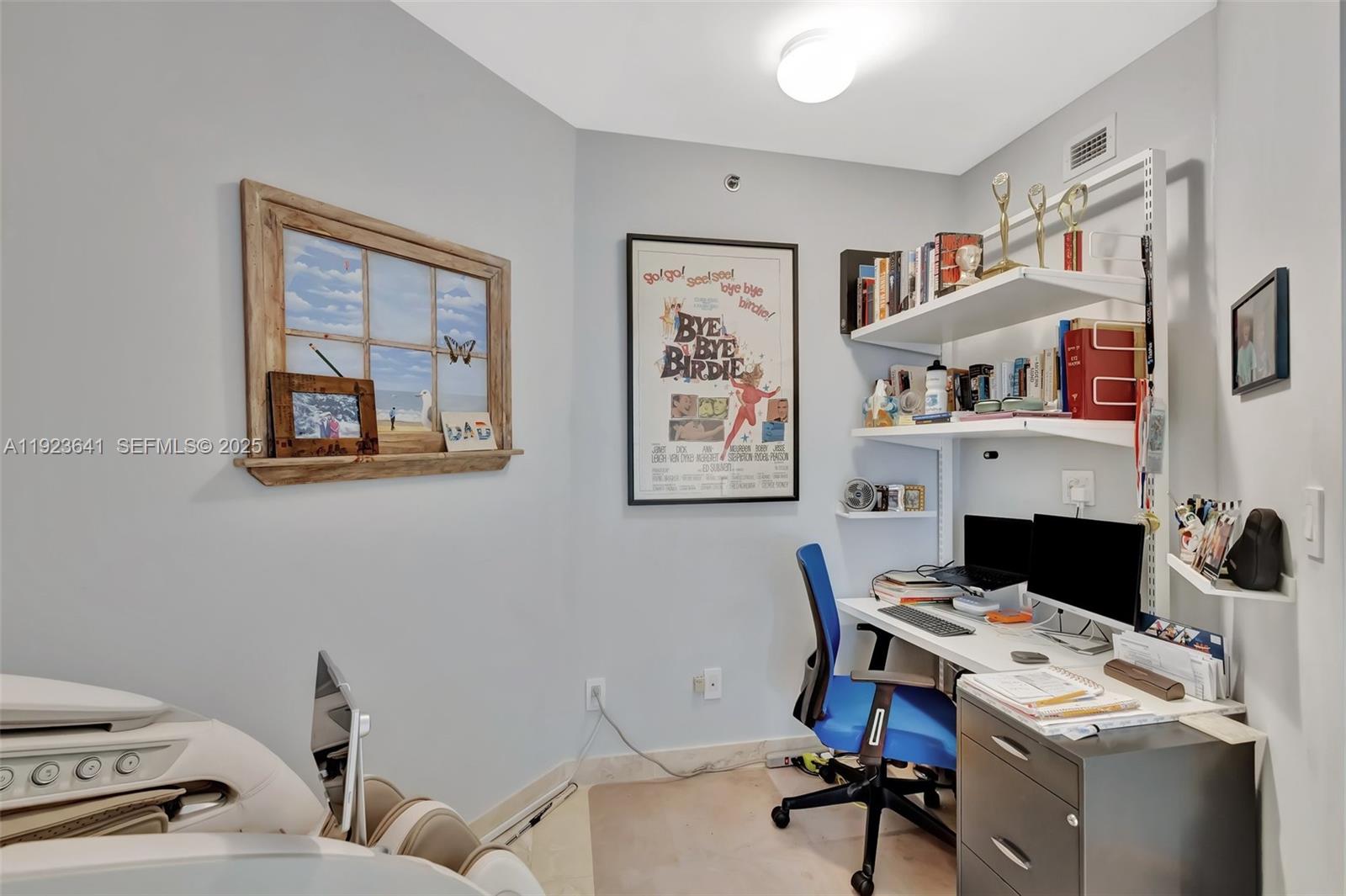 7000 Island Boulevard, Unit 1701 Aventura, FL 33160 - Photo 20 of 65 a view of a workspace with furniture and a fireplace