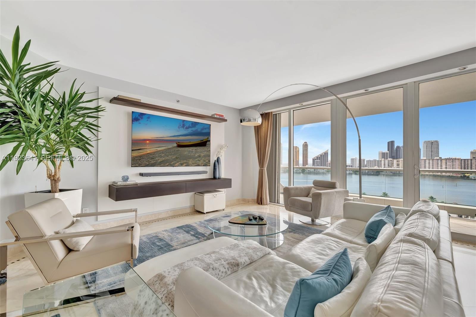 7000 Island Boulevard, Unit 1701 Aventura, FL 33160 - Photo 2 of 65 a living room with furniture and a large window