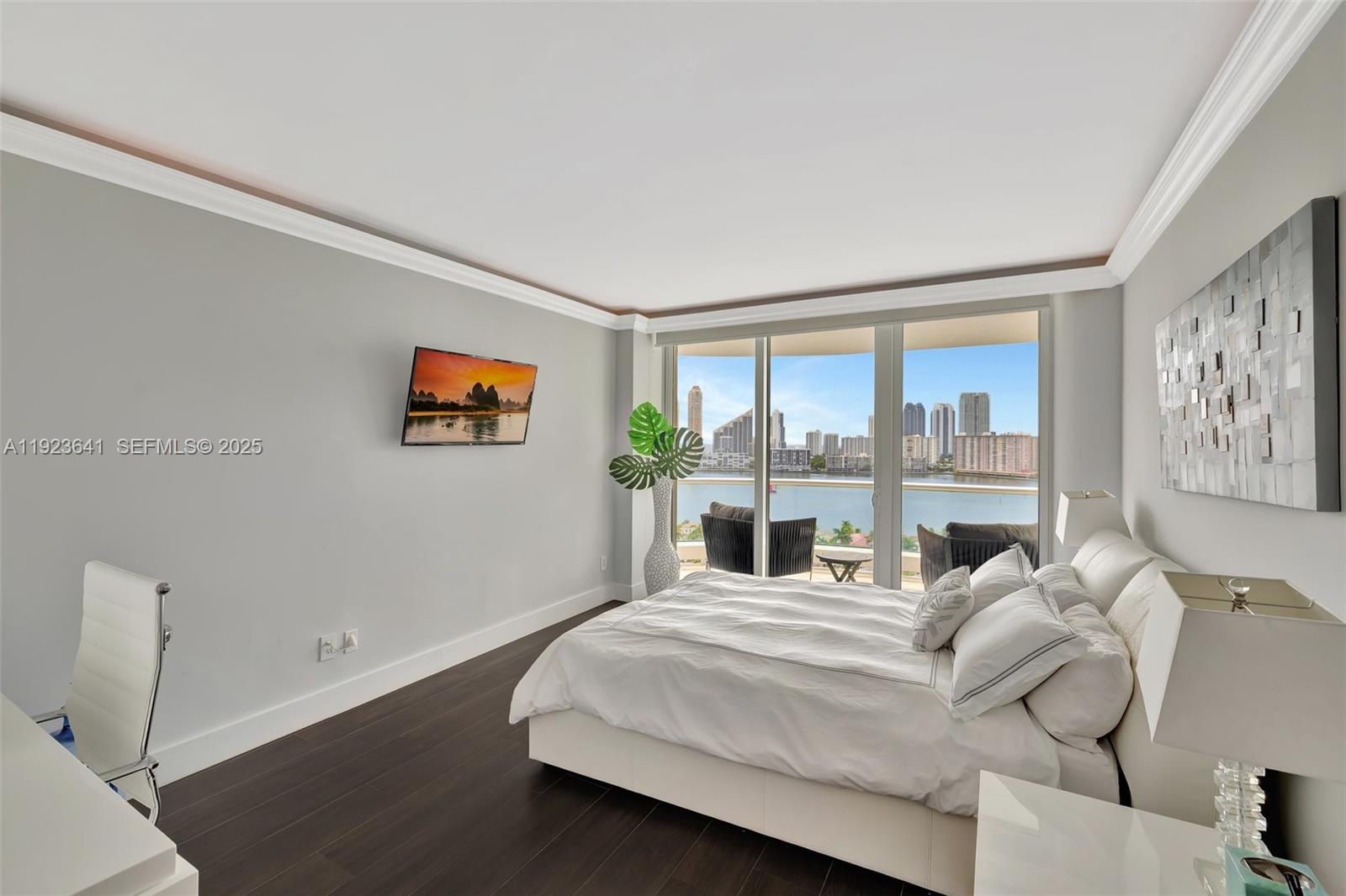 7000 Island Boulevard, Unit 1701 Aventura, FL 33160 - Photo 21 of 65 a bed room with a bed and a large window