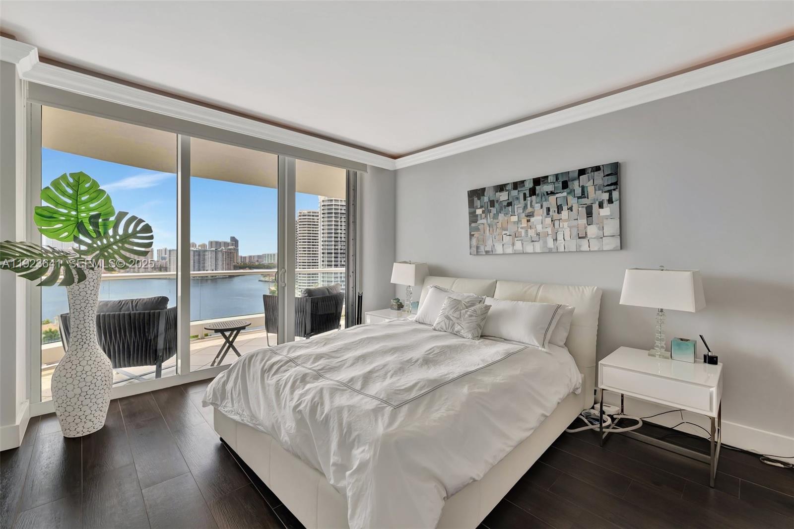 7000 Island Boulevard, Unit 1701 Aventura, FL 33160 - Photo 22 of 65 a bedroom with a large bed and a fireplace