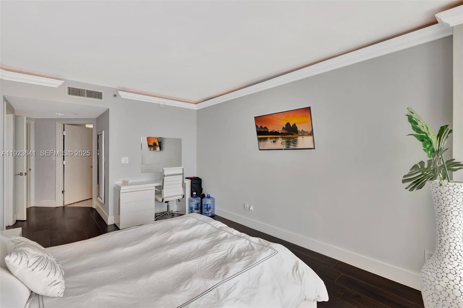 7000 Island Boulevard, Unit 1701 Aventura, FL 33160 - Photo 23 of 65 a bedroom with a bed and a potted plant