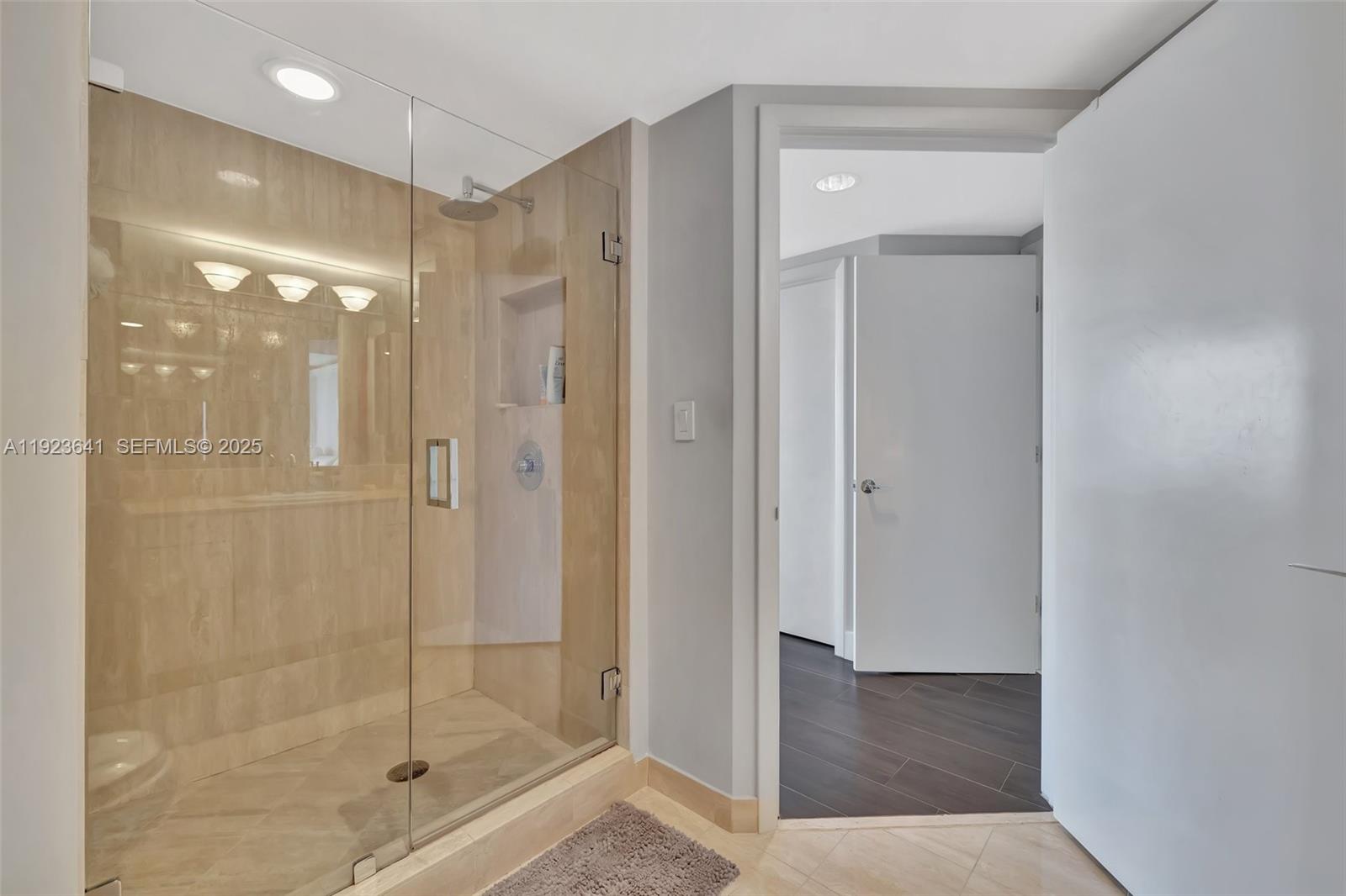 7000 Island Boulevard, Unit 1701 Aventura, FL 33160 - Photo 25 of 65 a bathroom with a shower and a glass door