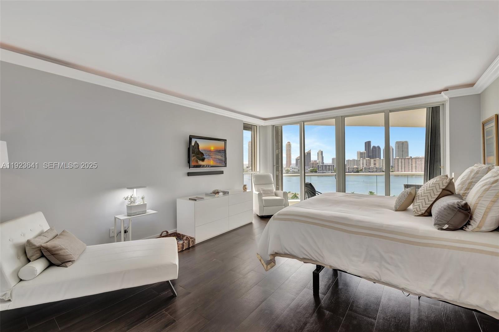 7000 Island Boulevard, Unit 1701 Aventura, FL 33160 - Photo 26 of 65 a bedroom with a bed and large window