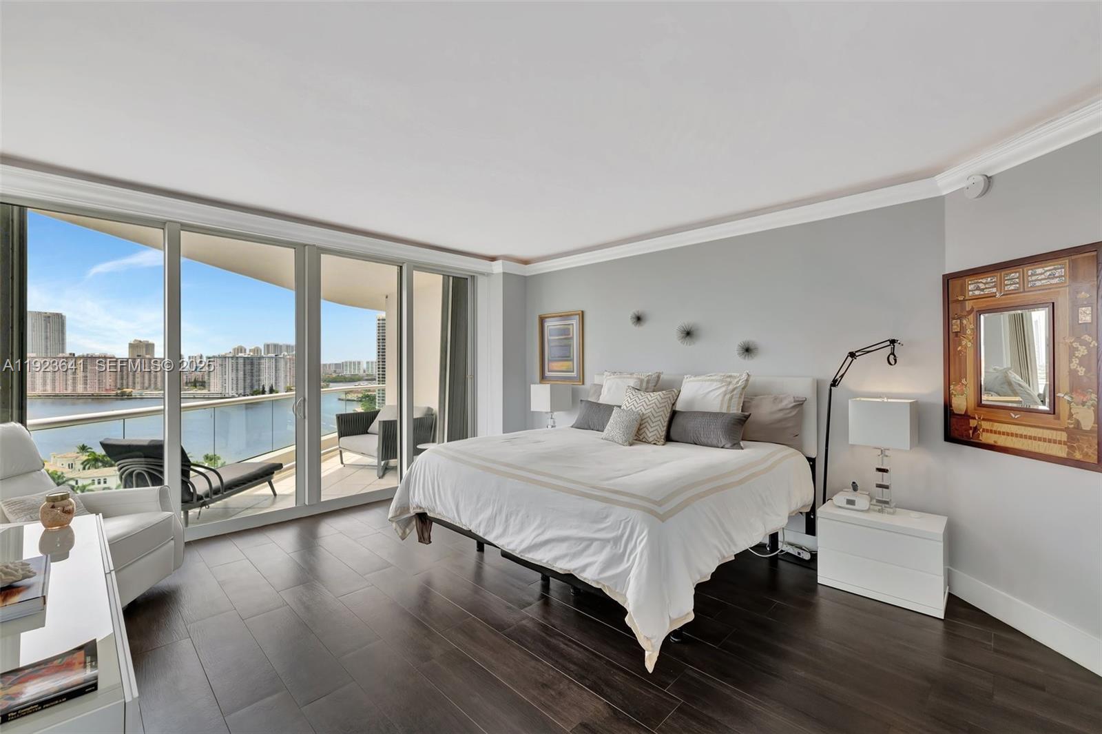 7000 Island Boulevard, Unit 1701 Aventura, FL 33160 - Photo 27 of 65 a bedroom with a large bed and a large window