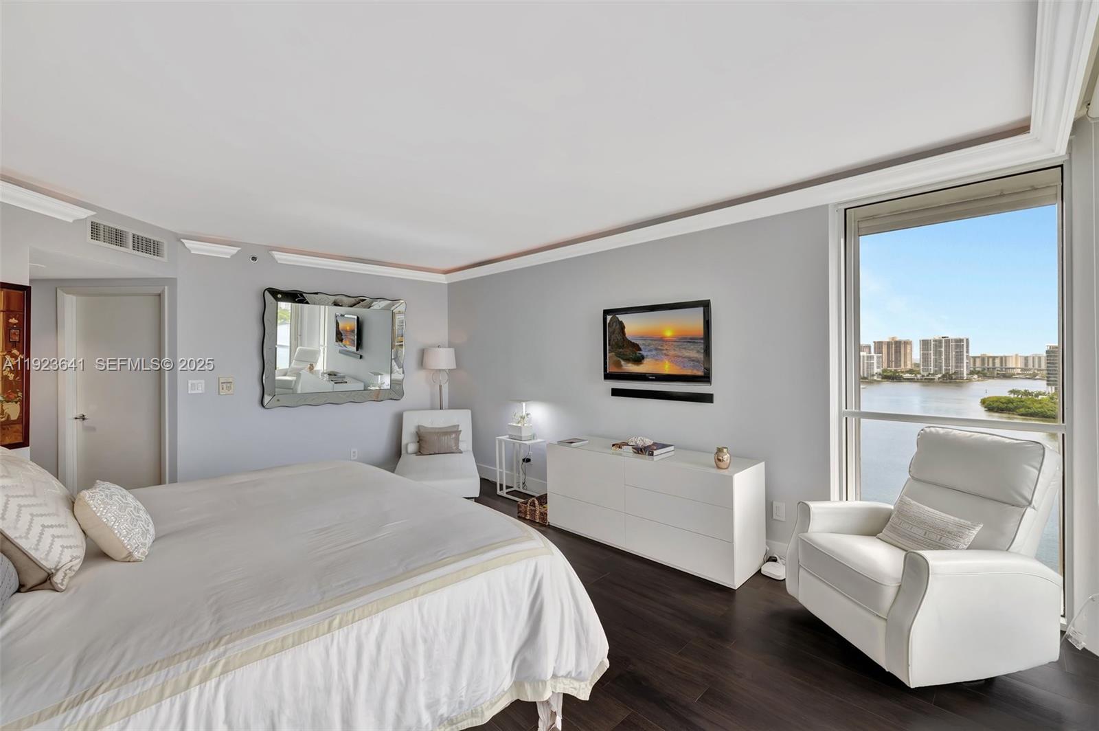 7000 Island Boulevard, Unit 1701 Aventura, FL 33160 - Photo 28 of 65 a bedroom with a bed and a couch