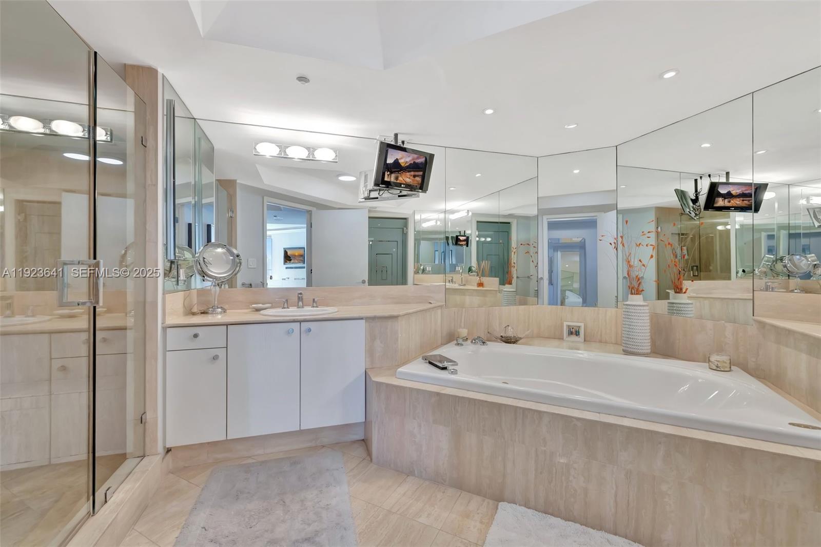 7000 Island Boulevard, Unit 1701 Aventura, FL 33160 - Photo 30 of 65 a spacious bathroom with a sink mirror and shower