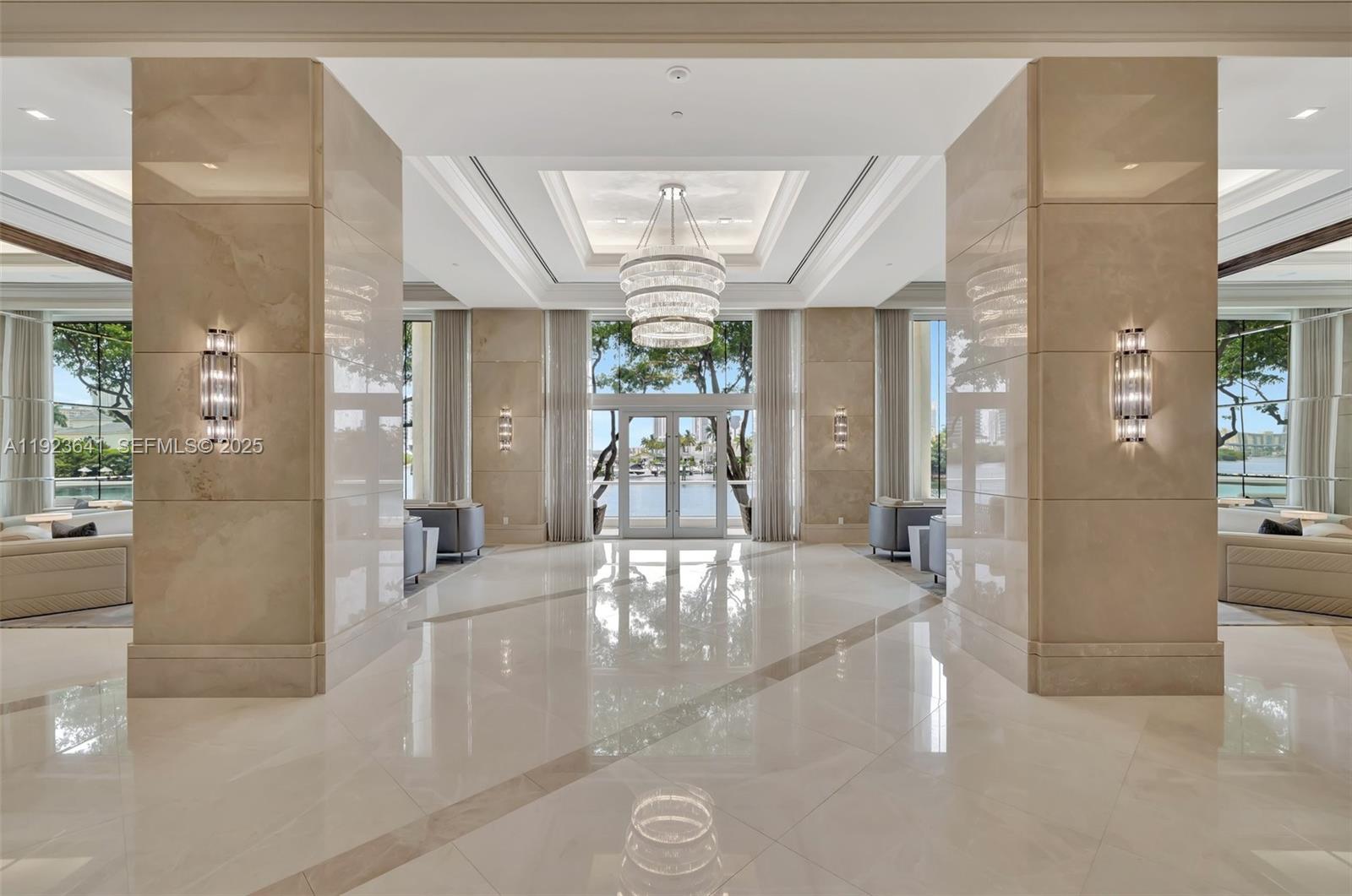7000 Island Boulevard, Unit 1701 Aventura, FL 33160 - Photo 34 of 65 a view of a hallway with furniture and a chandelier