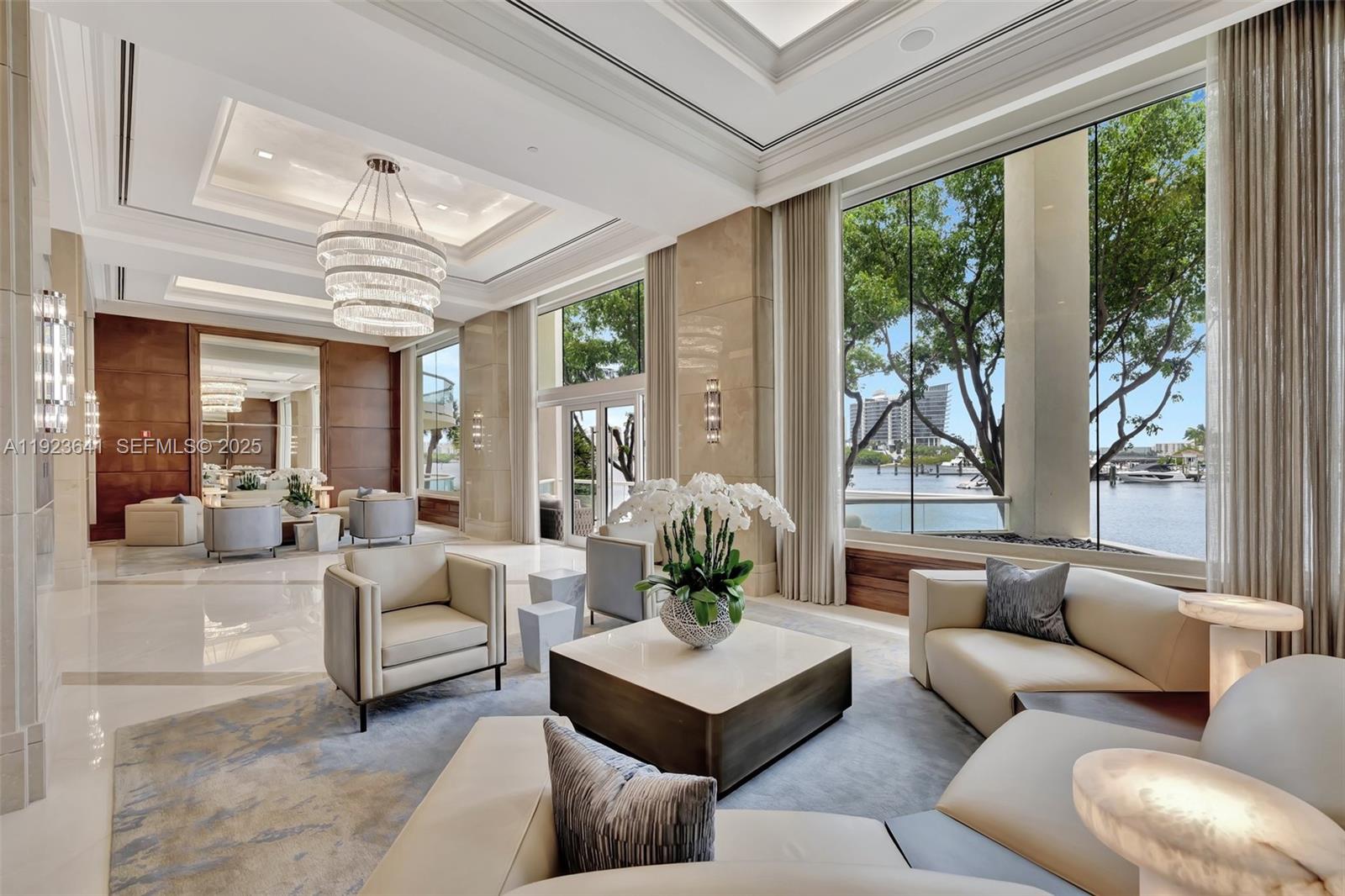 7000 Island Boulevard, Unit 1701 Aventura, FL 33160 - Photo 35 of 65 a living room with furniture and a large window