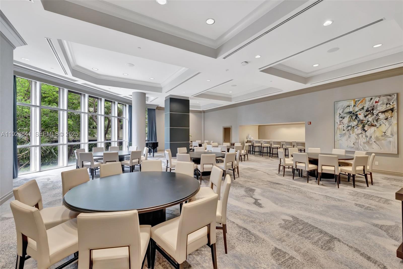 7000 Island Boulevard, Unit 1701 Aventura, FL 33160 - Photo 37 of 65 a dining room with furniture a large window and a rug