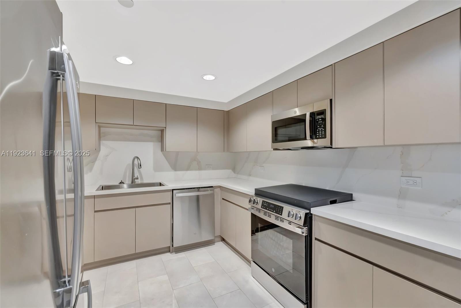 7000 Island Boulevard, Unit 1701 Aventura, FL 33160 - Photo 39 of 65 a kitchen that has a sink and a stove top oven