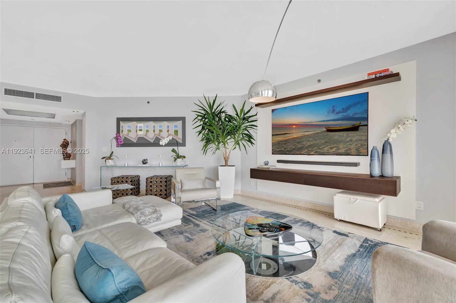 7000 Island Boulevard, Unit 1701 Aventura, FL 33160 - Photo 4 of 65 a living room with furniture and a painting