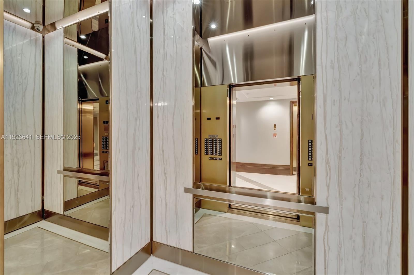 7000 Island Boulevard, Unit 1701 Aventura, FL 33160 - Photo 45 of 65 a bathroom with a glass shower door and mirror