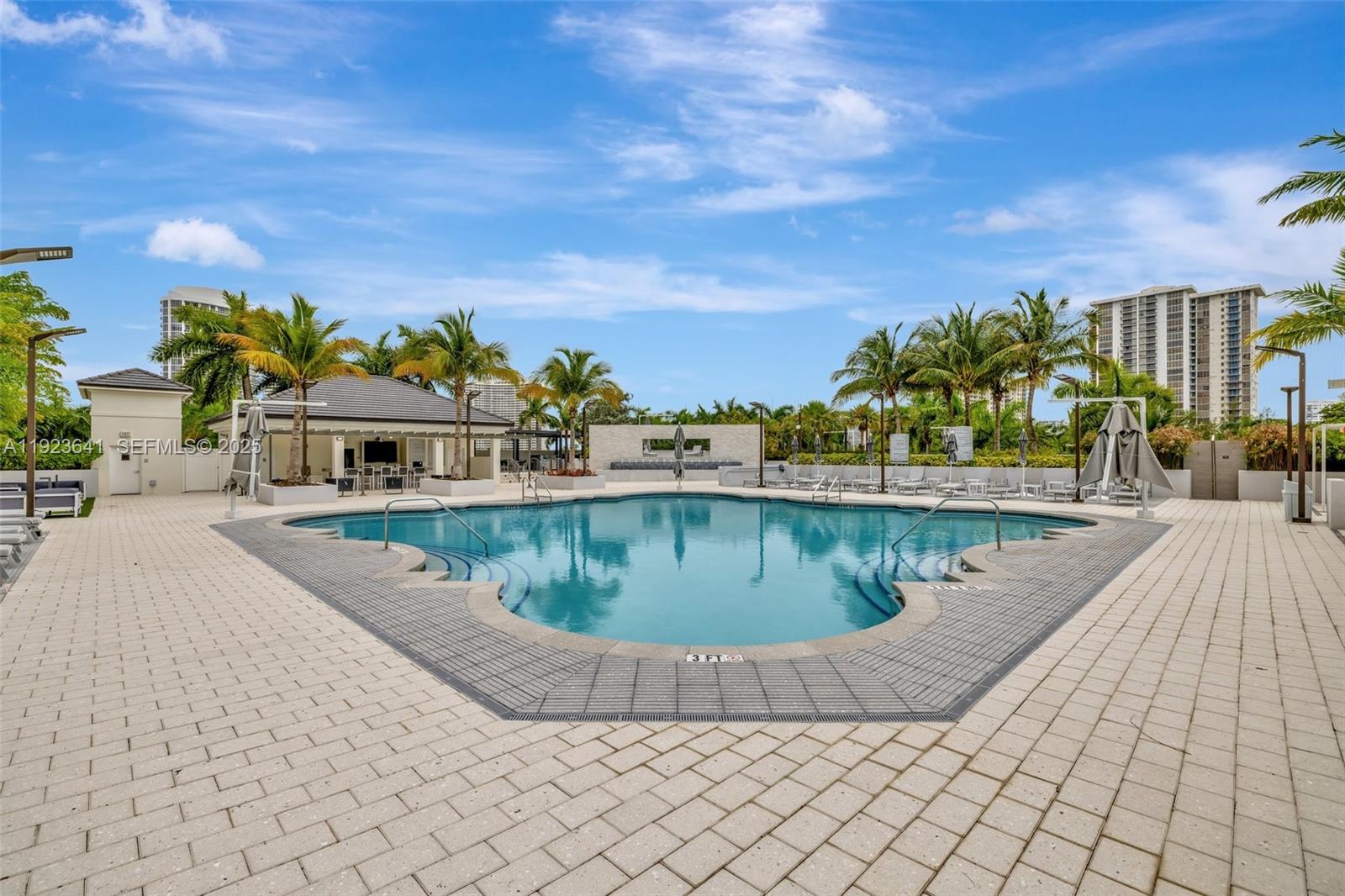 7000 Island Boulevard, Unit 1701 Aventura, FL 33160 - Photo 48 of 65 a view of a swimming pool with a yard