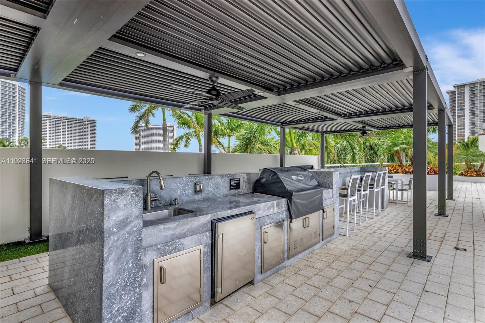 7000 Island Boulevard, Unit 1701 Aventura, FL 33160 - Photo 51 of 65 a kitchen with table and chairs