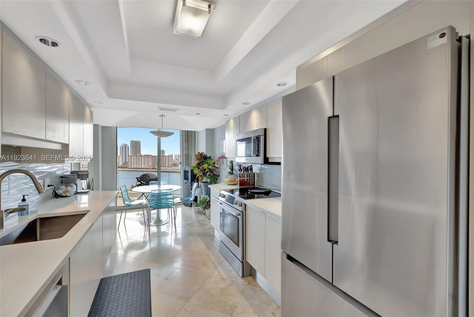 7000 Island Boulevard, Unit 1701 Aventura, FL 33160 - Photo 7 of 65 a kitchen with stainless steel appliances a refrigerator a sink a stove and white cabinets