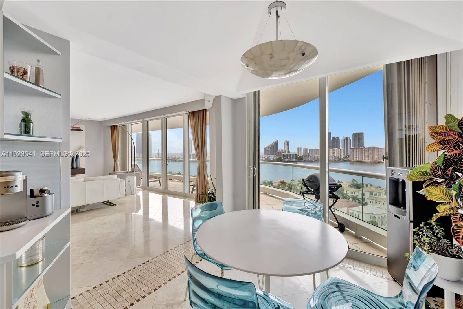 7000 Island Boulevard, Unit 1701 Aventura, FL 33160 - Photo 9 of 65 a very nice looking living room with a large window and furniture