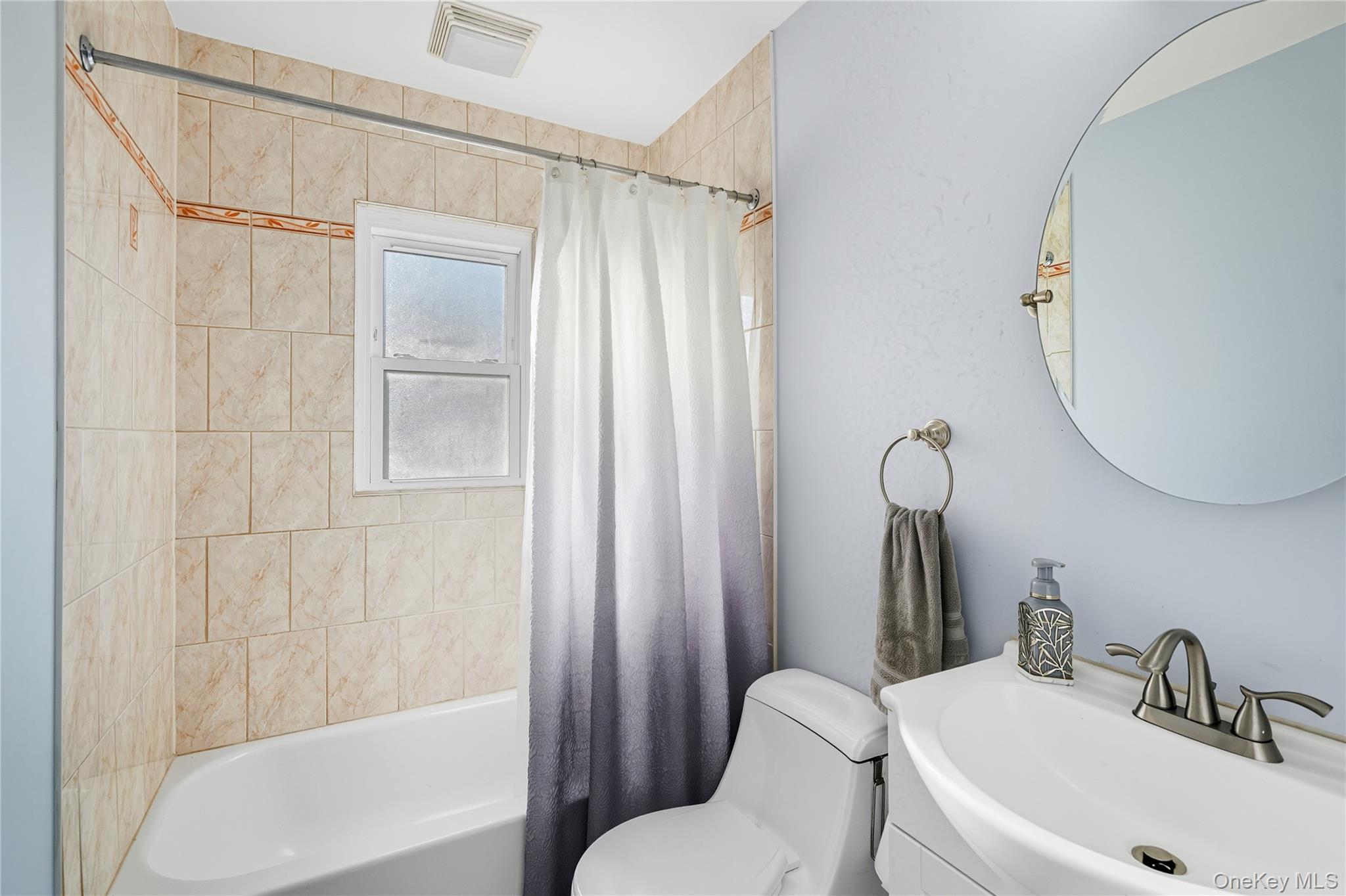 131 South 5th Street Bethpage, NY 11714 - Photo 12 of 21 a bathroom with a sink toilet and shower