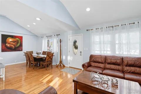 a dining room with furniture and wooden floor