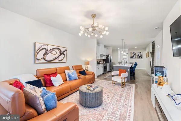 a living room with furniture and a chandelier